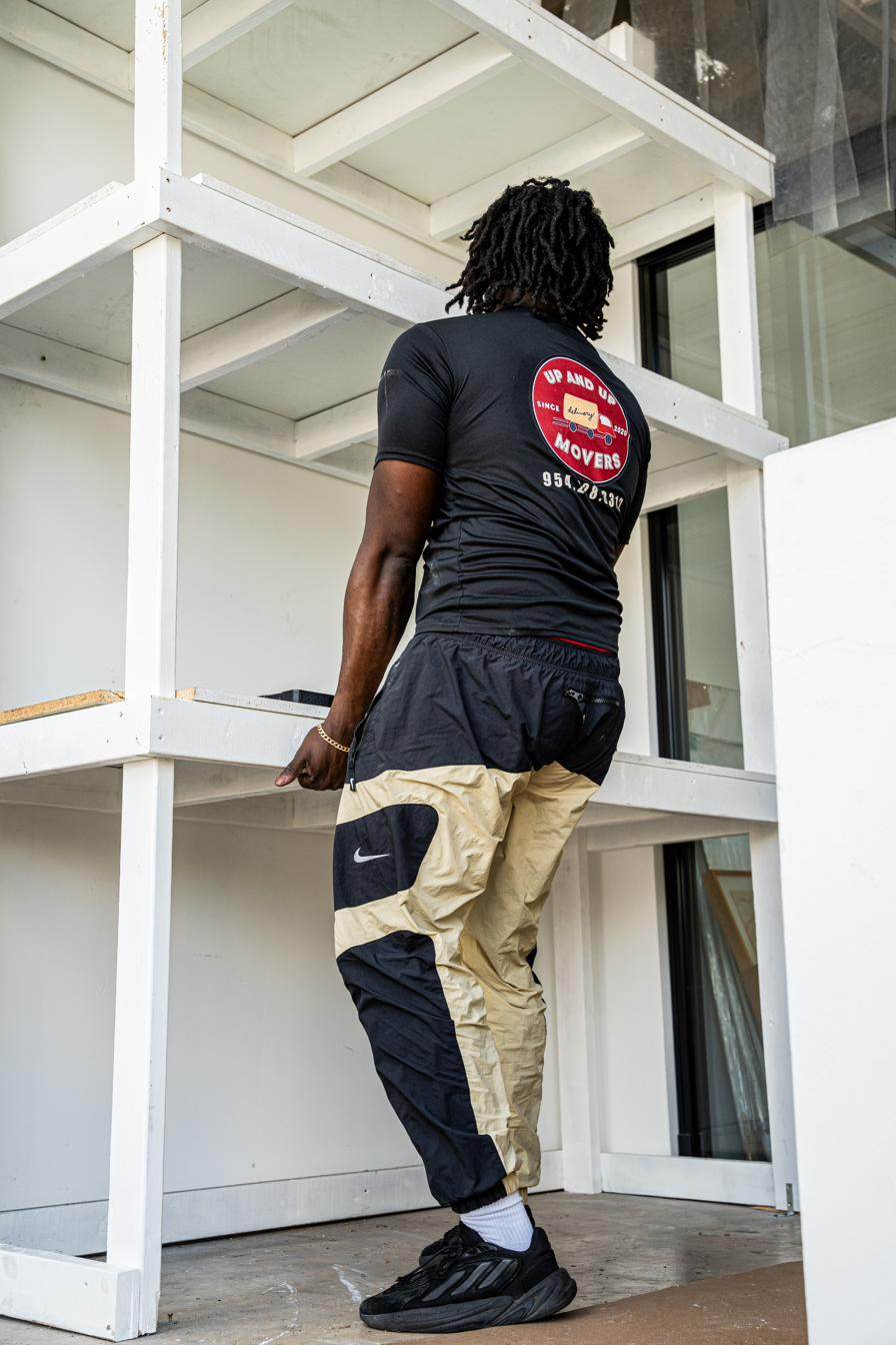 Up and Up Movers crew team-lifting furniture at a Miami job site