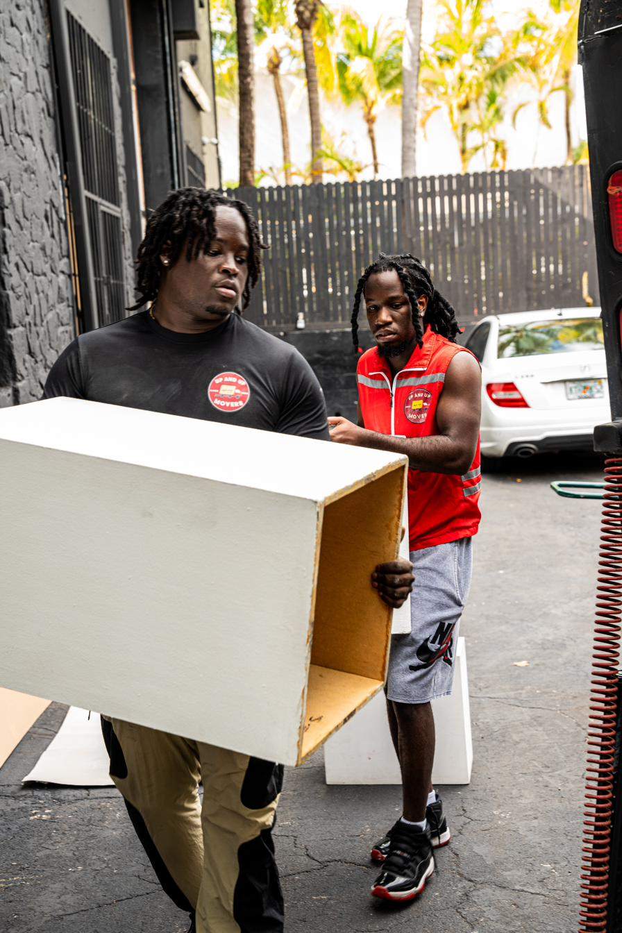 Up and Up mover reassembling furniture with a drill after a South Florida move