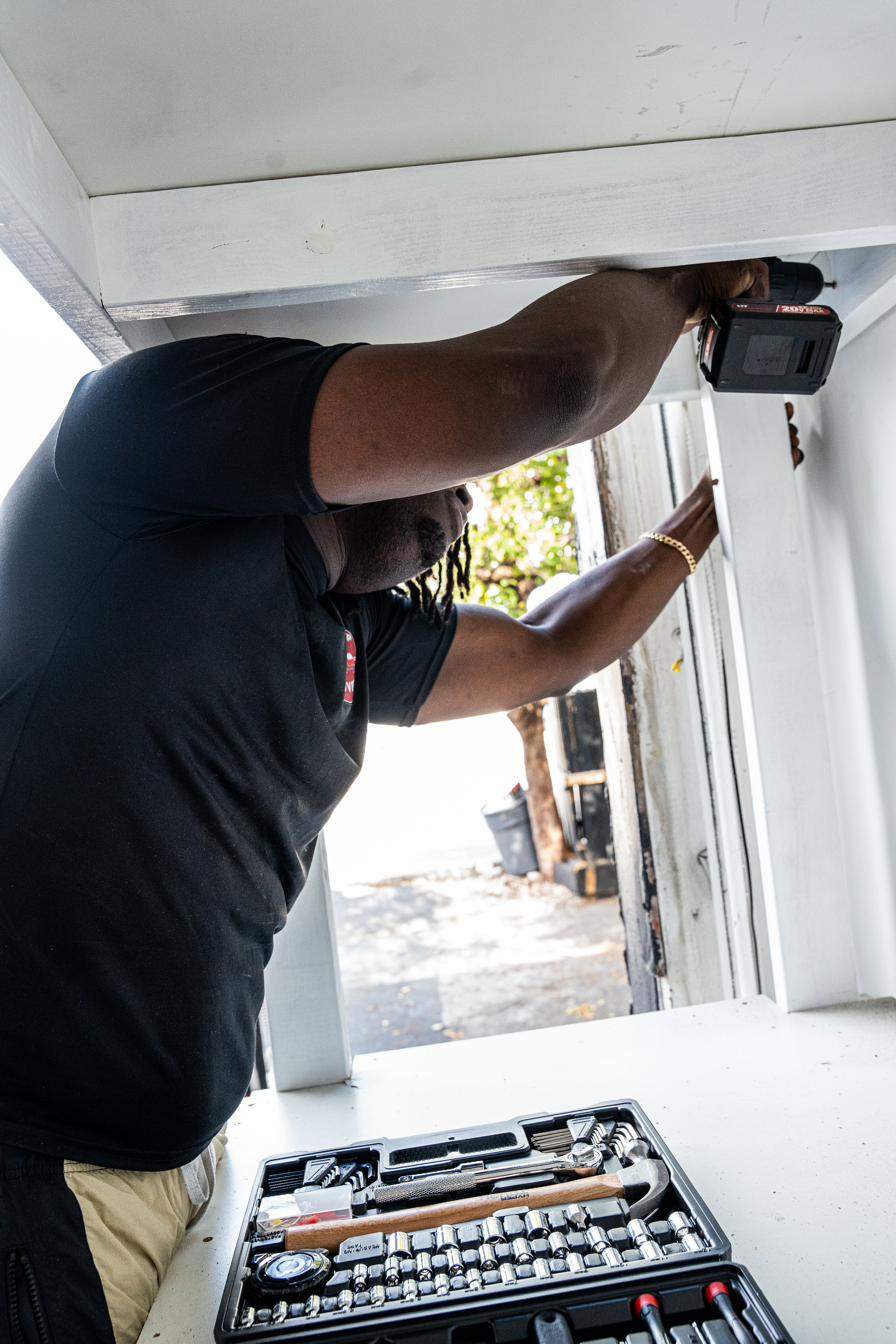 Up and Up mover carrying a protective-wrapped cushion in South Florida